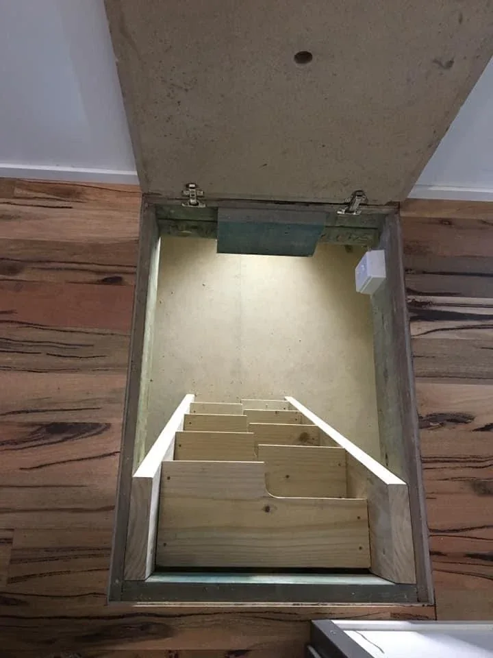 Custom hidden floor storage hatch in timber flooring